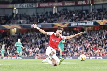  ?? — AFP photo ?? Arsenal’s Gabonese striker Pierre-Emerick Aubameyang scores his team’s first goal during the UEFA Europa League group E football match between Arsenal and Vorskla Poltava at the Emirates Stadium in London on September 20, 2018.