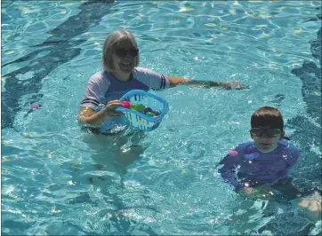  ?? PHOTOS BY NICK SESTANOVIC­H — THE REPORTER ?? Vacaville resident Patt King swims with her 8-year-old grandson Jonah Wrenne, visiting from San Francisco, to search for eggs in the Vacaville Parks and Recreation Department’s Underwater Egg Hunt. The annual event, which was canceled last year following the stay-at-home orders initiated by the COVID-19 pandemic, returned this year with social distancing measures in place.