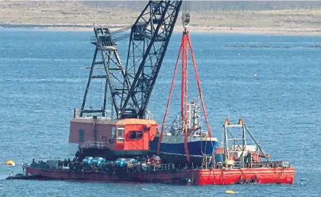  ?? ?? The Nancy Glen fishing trawler sits on a barge on Loch Fyne at Tarbert, its home port, after being recovered.