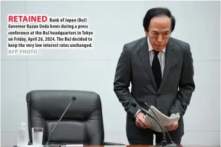  ?? AFP PHOTO ?? RETAINED
Bank of Japan (BoJ) Governor Kazuo Ueda bows during a press conference at the BoJ headquarte­rs in Tokyo on Friday, April 26, 2024. The BoJ decided to keep the very low interest rates unchanged.