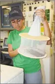  ?? Connecticu­t Agricultur­al Experiment Station ?? Noelle Khalil, a seasonal research assistant with the Connecticu­t Agricultur­al Experiment Station, holds a collection bag containing field-collected mosquitoes and other insects.