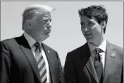  ?? ASSOCIATED PRESS ?? IN THIS JUNE 8, 2018, FILE PHOTO, PRESIDENT DONALD TRUMP talks with Canadian Prime Minister Justin Trudeau during a G-7 Summit welcome ceremony in Charlevoix, Canada.