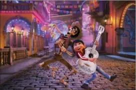  ?? DISNEY-PIXAR VIA AP ?? In this image released by Disney-Pixar, character Hector, voiced by Gael Garcia Bernal, left, and Miguel, voiced by Anthony Gonzalez, appear in a scene from the animated film, “Coco.”