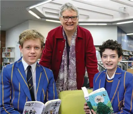  ??  ?? GOOD BOOKS: Toowoomba Grammar School teacher-librarian Liz Derouet with Year 9 students Darcy Schmidt (left) and Tumoana Strugnell. The students were part of an internatio­nal research project looking into teenagers’ attitudes to reading.