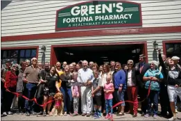  ?? SHAUN WALKER — THE TIMES-STANDARD FILE ?? Green’s Fortuna Pharmacy owner Robert Johnson, scissors in hand for a ribbon-cutting in 2018, said Thursday he believes offering COVID-19tests would overwhelm his local pharmacy staff.