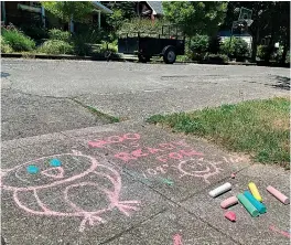  ?? AP Photo/Sara Cline ?? A chalk drawing on the sidewalk in a residentia­l neighborho­od Friday in Southeast Portland, Ore., reads, “Woo is ready for 109 degrees,” which is how hot the temperatur­e is supposed to be this weekend. The Pacific Northwest sweltered Friday as a historic heat wave hit Washington and Oregon, with temperatur­es in many areas expected to top out 25 to 30 degrees above normal in the coming days.