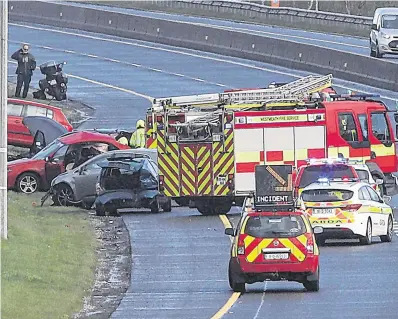  ?? PHOTO: PADDY CUMMINS ?? Scene: The fire service and gardaí on the M6.
