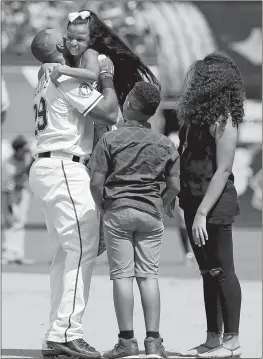  ?? TONY GUTIERREZ/AP PHOTO ?? Adrian Beltre of the Rangers is greeted by his children, Cassandra, top, Adrian Jr., and Canila, right, on the field after Beltre got his 3,000th career hit during Sunday’s game against the Orioles at Arlington, Texas.