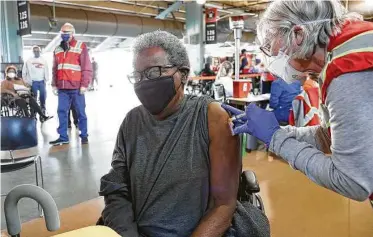  ?? Photos by Elizabeth Conley / Staff photograph­er ?? Perline Lockett, 86, gets her COVID-19 shot by nurse practition­er Jill Atmar on Saturday at Minute Maid Park. UH researcher­s have joined a national effort to fight reluctance to get the shots.