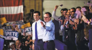  ?? Zbigniew Bzdak / Tribune News Service ?? South Bend Mayor Pete Buttigieg celebrates with husband Chasten Buttigieg after making an announceme­nt to run for president in the 2020 election on April 14 at Studebaker Building 84 in downtown South Bend, Ind. When it came to raising political money, Buttigieg was the favorite candidate in Connecticu­t in the race for the White House during the second quarter of the year.