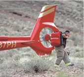  ??  ?? First responders arrive at the scene of a deadly helicopter crash in the Grand Canyon on Saturday.