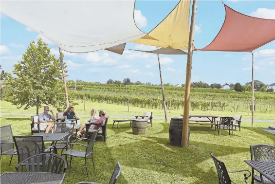  ?? PITTSBURGH POST-GAZETTE PHOTO ?? COME SAIL AWAY: Visitors to Fabbioli Cellars in Leesburg, Va., enjoy their wine under sails in an outdoor area overlookin­g the vineyard. Tastings are also held in a windowed tasting room or in the cellar alongside the barrels.