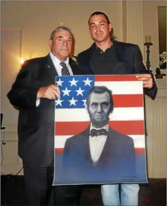  ?? PHOTOS BY FRAN MAYE — DIGITAL FIRST MEDIA ?? Fred McCarthy, right, presents former Kennett Square Police Chief Ed Zunino with an original painting of Abraham Lincoln.