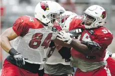  ?? ROSS D. FRANKLIN/THE ASSOCIATED PRESS ?? Alex Bazzie, right, seen during the Arizona Cardinals’ training camp last month, is a B.C. Lion again.