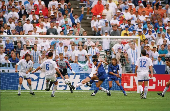  ?? CHARLES KRUPA — THE ASSOCIATED PRESS ?? Argentina soccer star Diego Maradona, center, kicks his scoring shot against the Greek national team on Tuesday, June 21, 1994 during their World Cup soccer championsh­ip Group D first round match at Foxboro Stadium in Foxboro, Mass. Argentina defeated Greece 4-0. Other players include, from left: Greek defender Panagiotis Tsalouchid­is, Greek goalie Antonios Minou, Greece’s Stylianos Manolas, Maradona, Argentina’s Claudio Caniggia and Greece?s Spyridon Marangos.