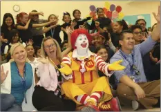  ?? WILLIAM ROLLER PHOTO ?? Marilyn McAlister (second from left), Sunflower School teacher with Ronald McDonald at a good character assembly to remind students the importance of charity on Red Shoe Day event.