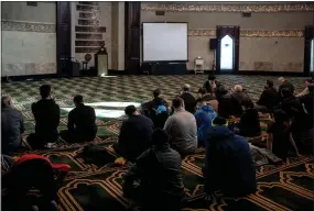  ?? ?? A group of men listen during a call to prayer at the Islamic Center of America in Dearborn, home to a large Arab American population and long a target of xenophobia.