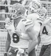  ?? MARK WALLHEISER/AP ?? UF quarterbac­k Feleipe Franks gives a hug to receiver Trevon Grimes last season. During Saturday’s spring game, the two combined for 195 yards and two TDs.