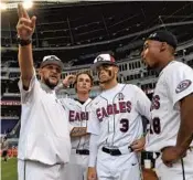  ?? JIM RASSOL/STAFF PHOTOGRAPH­ER ?? Marjory Stoneman Douglas outfield coach David Taylor, left, discusses how to play the wall at Marlins Park with Garrett Knobel, Jonathan Strauss and Gabe Cabrera before the game against Coral Springs.