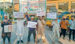  ?? — GANDHI ?? People hold placards against US President Donald Trump during a flash protest at Nalgonda Crossroads in Hyderabad on Monday.