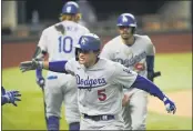  ?? ERIC GAY — THE ASSOCIATED PRESS ?? Los Angeles Dodgers’ Corey Seager celebrates his tworun home run against the Atlanta Braves during Game 5 of a baseball National League Championsh­ip Series on Friday in Arlington, Texas.