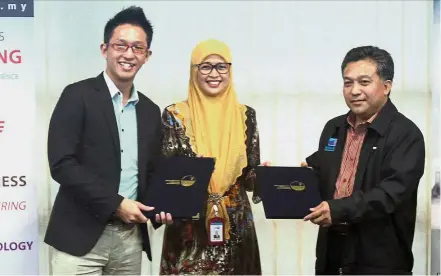  ??  ?? From left: Yap, Prof Siti Salbiah and Muhamad Sidik exchange documents at the event.