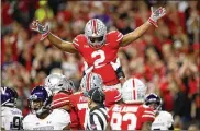  ?? JOE ROBBINS / GETTY IMAGES ?? Ohio State’s Chase Young (2) celebrates after a defensive play in the game against Northweste­rn in the Big Ten Championsh­ip game on Dec. 1.