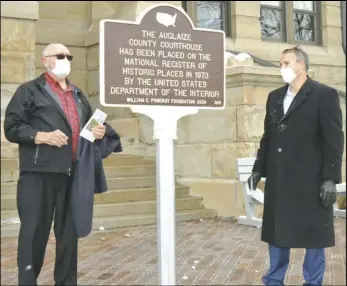  ?? Staff photo/ Alex Guerrero ?? Auglaize County Commission­ers Don Regula (left) and Doug Spencer flank the new marker outside the courthouse that notes the building’s recognitio­n as a part of the National Register of Historic Places.