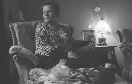  ?? PHOTOS: TYLER ANDERSON / NATIONAL POST ?? Tina Martino sits with some of her son’s belongings at her home in Niagara Falls. Nazzareno Tassone was killed a few days before Christmas while he was fighting with the Kurdish forces against ISIL in Syria. She was told his body was not recovered.