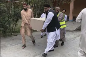  ?? (AP) ?? Volunteers carry a casket of a Chinese national, who was killed in the suicide bombing, at a hospital in Basham, in Shangla District in the Pakistan’s Khyber Pakhtunkhw­a province on Tuesday.