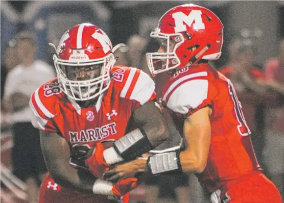  ?? | JEAN LACHAT/ FOR THE SUN- TIMES ?? Marist’s playoff run hinges on the success of quarterbac­k Mike Markett and running back Delonte Harrell. They face a tough task next against Loyola.