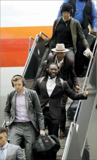  ?? ERIC GAY — THE ASSOCIATED PRESS ?? Eagles quarterbac­k Nate Sudfeld, second from bottom, is followed by running back LeGarrette Blount, linebacker Mychal Kendricks, and quarterbac­k Nick Foles, as they arrive Sunday in Minneapoli­s.