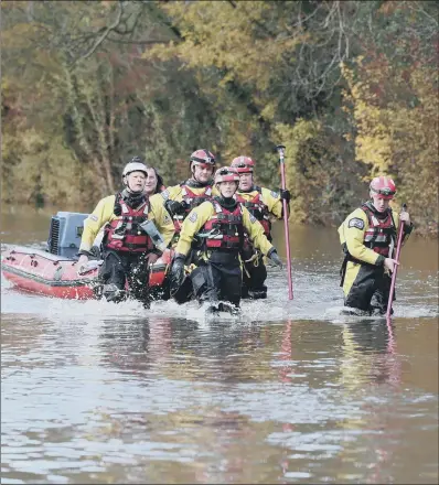  ?? PICTURE: PA WIRE ?? OPERATION: Rescuers pull a boat through floodwater in Fishlake, Doncaster, one of the communitie­s worst affected by the deluge.