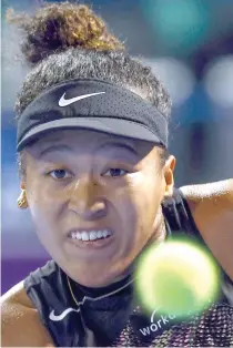  ?? AFP PHOTO ?? Japan’s Naomi Osaka in action in the round of 32 match against Croatia’s Petra Martic during their Women’s Singles tennis match at the Qatar WTA Open at Khalifa Internatio­nal Tennis and Squash Complex in Doha on Tuesday, Feb. 13, 2024.