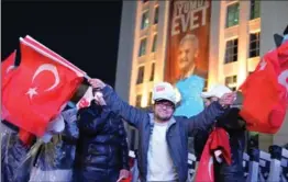  ?? ELIF SOGUT, GETTY IMAGES ?? Supporters of Turkey’s ruling AK party react to referendum results in Ankara.