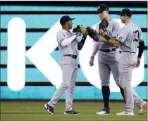  ?? LYNNE SLADKY - THE ASSOCIATED PRESS ?? New York Yankees left fielder Greg Allen, left, center fielder Aaron Judge, center, and right fielder Joey Gallo celebrate after the team’s 3-1win against the Miami Marlins on Friday.