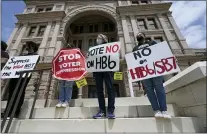  ?? ERIC GAY — THE ASSOCIATED PRESS FILE ?? In this April 21, 2021, file photo, people opposed to
Texas voter bills HB6 and SB7 hold signs during a news conference hosted by Texas Rising Action on the steps of the State Capitol in Austin, Texas. Republican lawmakers around the country are pressing ahead with efforts to tighten voting laws, despite growing warnings from business leaders that the measures could harm democracy and the economic climate.