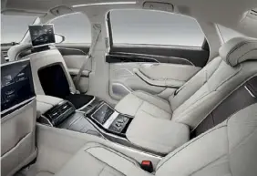  ??  ?? Back seat driving: besides AI motion systems, the latest A8 has a TV, touchscree­ns and a foot massager
