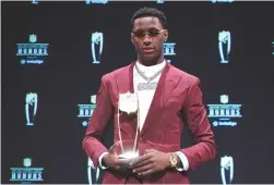  ?? (Kirby Lee/USA TODAY Sports) ?? NEW YORK JETS cornerback Sauce Gardner poses for a photo after receiving the award for AP Defensive rookie of the Year during the NFL Honors award show at Symphony Hall.