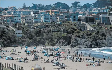  ?? JEFF CHIU/AP ?? People visit San Francisco’s Baker Beach on Sunday. California has recorded more than 3,700 deaths from coronaviru­s.