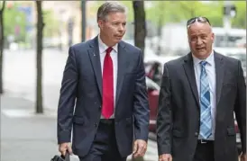  ?? Andrew Rush/Post-Gazette ?? Former Allegheny County Councilman Chuck McCullough, left, arrives at the Allegheny County Courthouse on Wednesday.