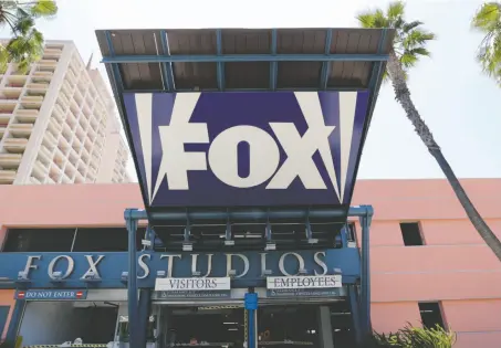  ?? AP PHOTO/REED SAXON, FILE ?? This 2013 file photo shows an entrance to a parking garage at 20th Century-Fox studios, an entity owned by News Corporatio­n in Los Angeles. Disney announced Thursday that it is buying a large part of Fox.