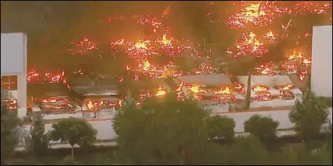  ?? ASSOCIATED PRESS ?? This photo taken from video provided by KABC-TV shows a raging fire destroying a huge commercial building Friday in Redlands. The fire early Friday destroyed a distributi­on facility that was used to ship items to Amazon customers.