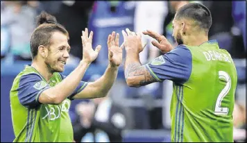  ?? TED S. WARREN / ASSOCIATED PRESS ?? Seattle Sounders forward Harry Shipp is congratula­ted by forward Clint Dempsey after scoring a goal against the New York Red Bulls.