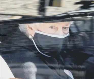  ?? PHOTO: GETTY ?? Caption
The Queen peers out of a car window on her way to the service.