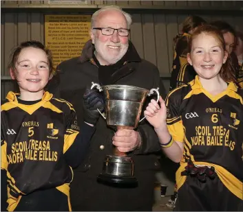  ??  ?? Joint captains Ciara Kenny and Eabha Guinan receiving the trophy from Kevin Waters (Chairman).