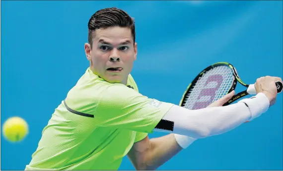  ?? — THE ASSOCIATED PRESS ?? Milos Raonic of Thornhill, Ont., lines up a backhand against Illya Marchenko of Ukraine during their first-round match at the Australian Open tennis championsh­ip in Melbourne Tuesday. Raonic won and will face Donald Young of the U.S. in the second round.