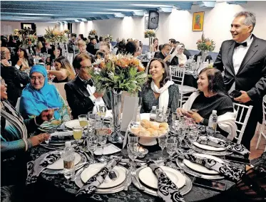  ?? | IAN LANDSBERG African News Agency (ANA) ?? MUSEUM curator Igshaan Higgins welcomes guests including the Survé family to the gala dinner fundraiser hosted by the Cape Heritage Museum at the Castle of Good Hope on Saturday evening.