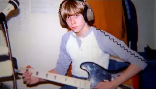  ??  ?? A young Kurt Cobain composing music.
