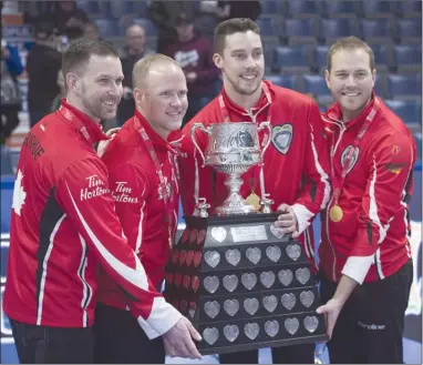  ?? The Canadian Press ?? Team Canada skip Brad Gushue, third Mark Nichols, second Brett Gallant and lead Geoff Walker, left to right, pose with the Brier Tankard after defeating Alberta 6-4 to win the Tim Hortons Brier at the Brandt Centre in Regina on Sunday, March 11. After...